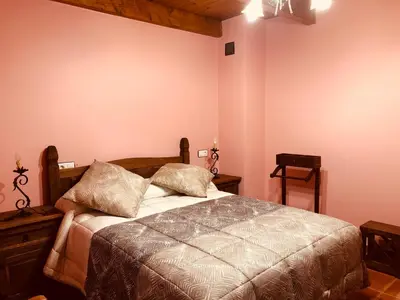 a bedroom with a bed with two pillows on it at Hotel Rural El Lagar De Las Médulas in Orellán