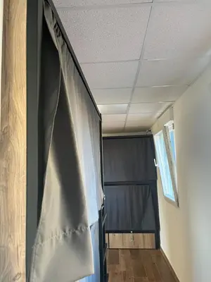 a living room with a curtain and a black curtain at Albergue Freixo in Palas de Rei