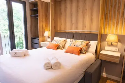 a bedroom with a large bed with towels on it at Treixadura in Pincelo