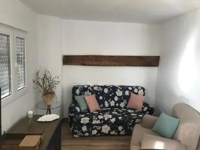 a living room with a couch and a chair at A Castelana de Cea in Cea