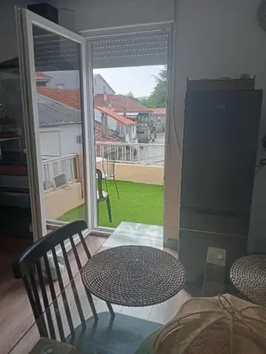 a room with a table and chairs and a sliding glass door at A Castelana de Cea in Cea
