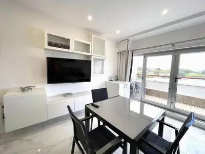 a dining room with a table and chairs and a television at housingcoruña BASTIAGUEIRO in Bastiagueiro