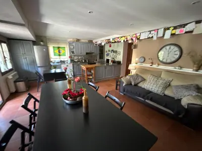 a living room with a table and a couch at Hostal Casa San Nicolas in Molinaseca