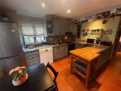 a kitchen with a table and a counter top at Hostal Casa San Nicolas in Molinaseca