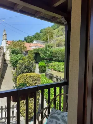 a view of a garden from a balcony at La Casina de Santulaya in Adralés