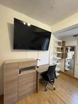 an office with a desk and a television on a wall at El Bierzo - Ponferrada in Ponferrada