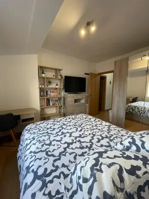 a bedroom with a bed with a blue and white blanket at El Bierzo - Ponferrada in Ponferrada