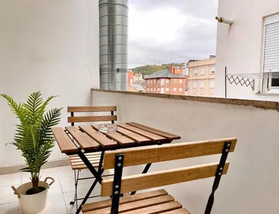 a wooden table and bench on a balcony at El Bierzo - Ponferrada in Ponferrada