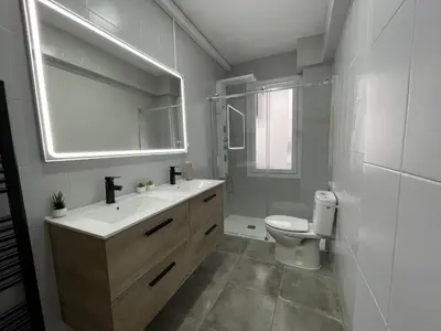 a bathroom with a sink and a toilet and a mirror at El Bierzo - Ponferrada in Ponferrada