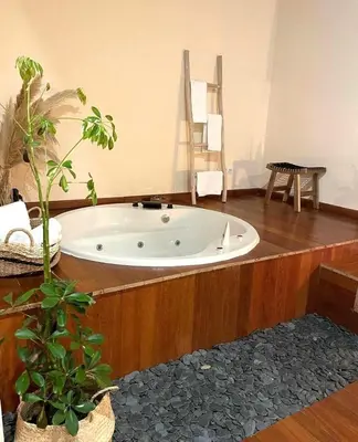 a bath tub in a room with a wooden floor at Couso Relax in Sarreaus