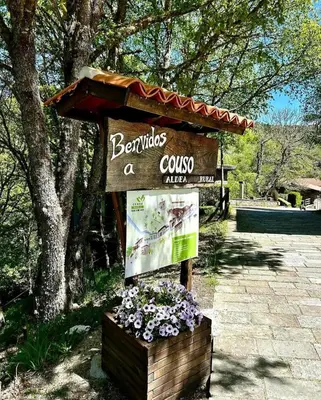 a sign for a course at a park with flowers at Couso Relax in Sarreaus
