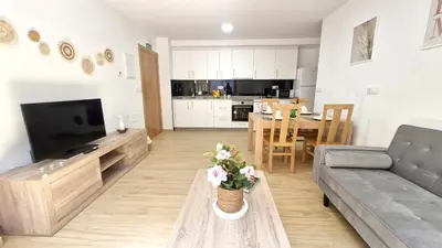 a living room with a couch and a table at Apartamentos Pedras do Val in Mondariz