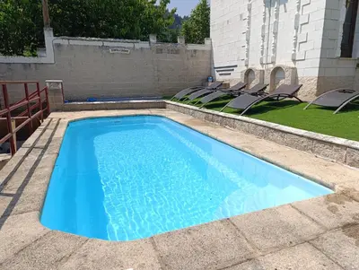 a swimming pool with chairs in a yard at Finca el Filandón in San Miguel de Arganza