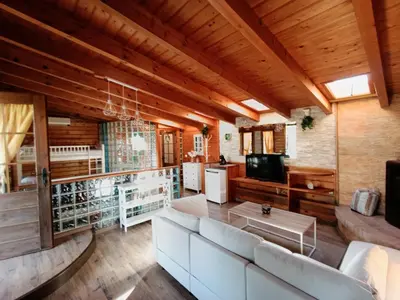a living room with a couch and a tv at Finca el Filandón in San Miguel de Arganza