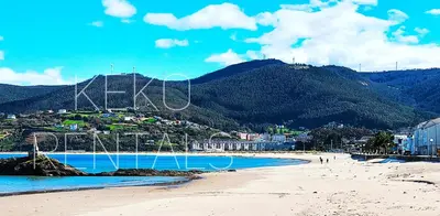 a view of a beach with a mountain in the background at Lannion in Viveiro