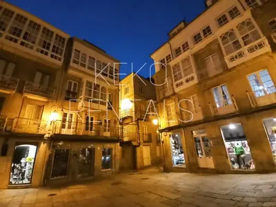 a group of buildings at night with lights at Lannion in Viveiro