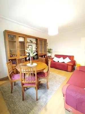 a living room with a table and chairs and a couch at Lannion in Viveiro