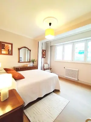 a bedroom with a large white bed and windows at Lannion in Viveiro