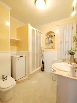 a bathroom with a white toilet and a sink at Lannion in Viveiro