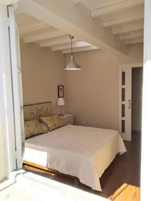 a bedroom with a bed and a large window at Casa Silandeira in Viveiro