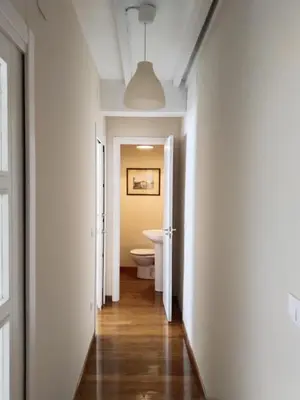 a hallway of a bathroom with a toilet in it at Casa Silandeira in Viveiro