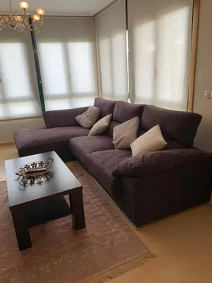 a living room with a couch and a coffee table at Sea, pool, and comfort in a duplex in Foz