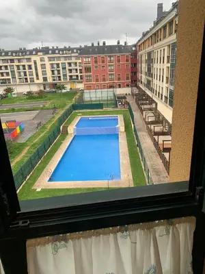 a view of a swimming pool from a window at Sea, pool, and comfort in a duplex in Foz