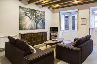 a living room with two couches and a table at Casa Baran in Sarria