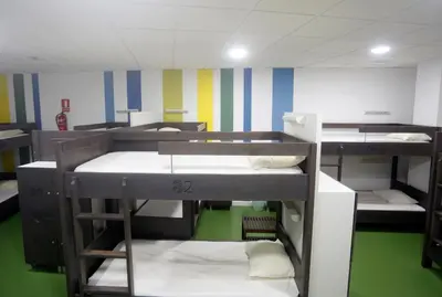 a group of bunk beds in a room at Albergue Spa Cruceiro de Pedrouzo in O Pedrouzo