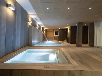 a jacuzzi tub in the middle of a room at Albergue Spa Cruceiro de Pedrouzo in O Pedrouzo