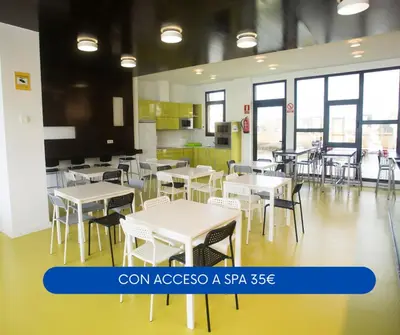 a cafeteria with white tables and chairs and windows at Albergue Spa Cruceiro de Pedrouzo in O Pedrouzo