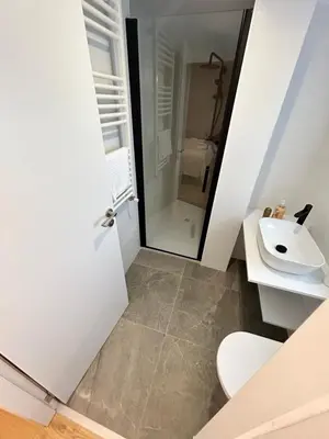 a bathroom with a white toilet and a sink at Pensión do Catro in Puebla de Trives