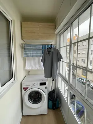 a washing machine in a laundry room with a window at Apartamento R14 en Miño con 2 dormitorios, salón-cocina, 1 baño y zona de lavandería, situado cerca de las playas in Miño