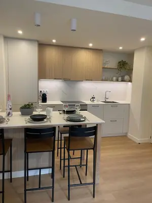 a kitchen with a table and some chairs in it at Apartamento R14 en Miño con 2 dormitorios, salón-cocina, 1 baño y zona de lavandería, situado cerca de las playas in Miño