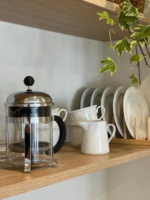 a kitchen counter with a coffee maker on a shelf at Apartamento R14 en Miño con 2 dormitorios, salón-cocina, 1 baño y zona de lavandería, situado cerca de las playas in Miño