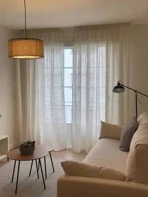 a living room with a couch and a window at Apartamento R14 en Miño con 2 dormitorios, salón-cocina, 1 baño y zona de lavandería, situado cerca de las playas in Miño