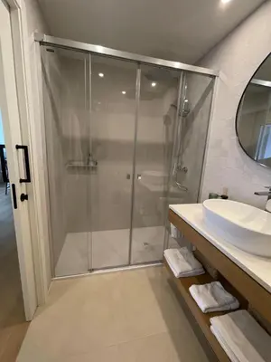 a bathroom with a glass shower and a sink at Apartamento R14 en Miño con 2 dormitorios, salón-cocina, 1 baño y zona de lavandería, situado cerca de las playas in Miño