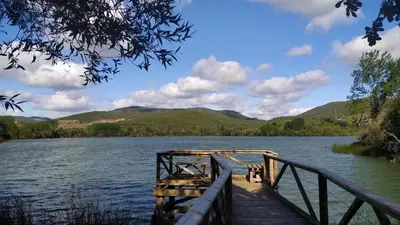 a dock on a lake with mountains in the background at Casa Divina in Lago de Carucedo