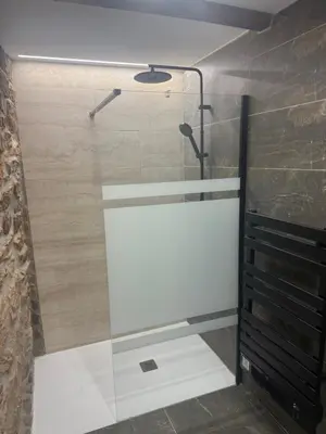 a shower with a glass door in a bathroom at Casa Divina in Lago de Carucedo