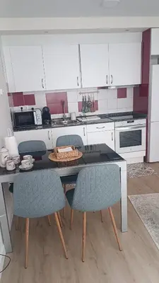 a kitchen with a table with chairs and a counter at Apartamento Galería Cine Colón in Ribadeo