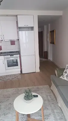 a living room with a couch and a table at Apartamento Galería Cine Colón in Ribadeo
