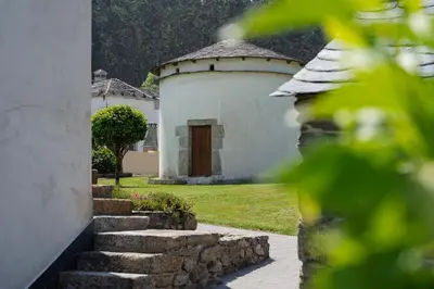 a small white building with a door in the yard at Casa Grande Da Torre in Landrove