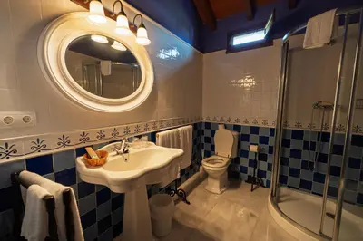 a bathroom with a sink and a toilet and a mirror at Casa Grande Da Torre in Landrove