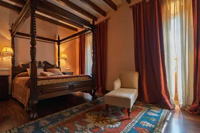 a bedroom with a canopy bed and a chair at Casa Grande Da Torre in Landrove