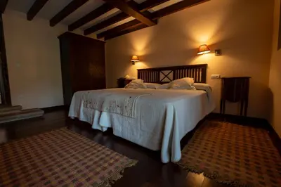 a bedroom with a large bed with white sheets at Casa Grande Da Torre in Landrove