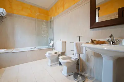 a bathroom with a toilet and a sink at Casa Grande Da Torre in Landrove
