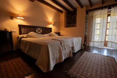 a bedroom with a bed with white sheets and a window at Casa Grande Da Torre in Landrove