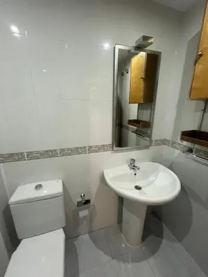 a white bathroom with a sink and a toilet at As Marismas - Miño in Miño
