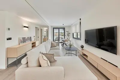 a living room with a large couch and a tv at AHH Atlantic Horizon Homes in Oleiros