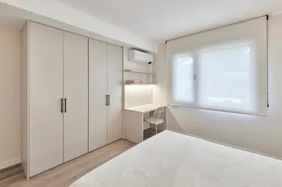 a kitchen with white cabinets and a sink at AHH Atlantic Horizon Homes in Oleiros